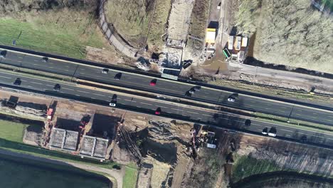 Bird's-eye-drone-shot-of-a-highway-and-construction-site