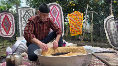 natural-fiber-mat-the-woolen-handmade-persian-traditional-carpet-rug-namad-felt-beating-sheep-wool-fabric-made-by-rolling-pressing-and-design-colorful-material-natural-culture-of-local-people-in-Iran