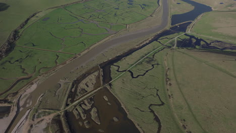 Aerial-shot-over-river-cuckmere-and-surrounding-marsh-land