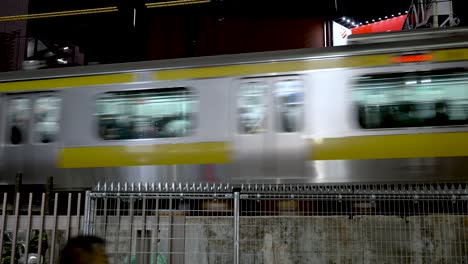 JR-Chuo-Train-Going-Past-Across-An-Elevated-Rail-In-Shinjuku-At-Night