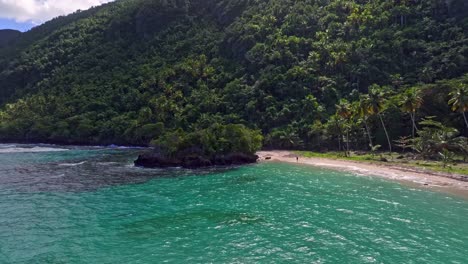 Sand-beach-and-steep-coastline-with-rainforest-in-tropical-Caribbean,-aerial