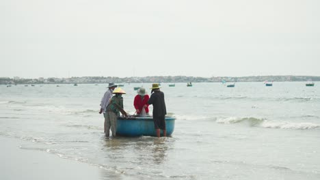 A-group-of-fishermen-are-bidding-for-a-fresh-catch-of-fish-just-caught-offshore