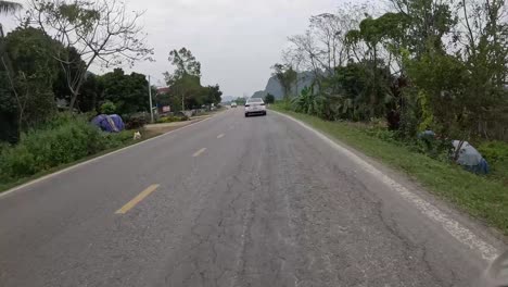 Car-overtaking-motorbike-extremely-close-in-Vietnam,-POV
