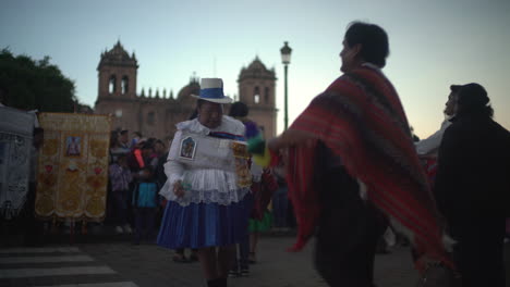 In-Cusco,-Peru,-a-vibrant-religious-celebration-unfolds-for-Nuestra-Señora-de-Fátima,-where-joyfully-adorned-women-and-men,-dressed-in-their-polleras-and-jobona,-parade-and-dance-through-the-streets