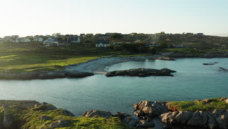 Embark-on-a-visual-journey-through-Connemara,-Galway,-Ireland,-with-a-compelling-drone-push-shot-capturing-the-lush-green-landscape-and-the-serene-beauty-of-its-coastal-beaches