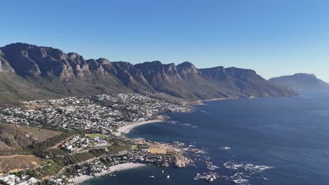 Twelve-Apostles-Mountains-and-Camps-Bay-Suburb-of-Cape-Town,-South-Africa-Drone-Shot