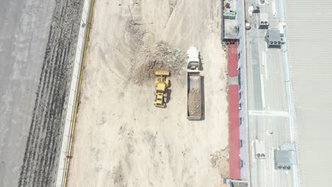 Debris-collection-after-demolition-with-a-bulldozer-and-a-loading-truck