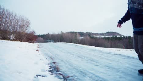 A-Man-is-Attempting-to-Navigate-Across-Icy-Terrain---Static-Shot