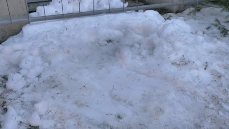 Worker-cleaning-street-from-snow-with-shovel