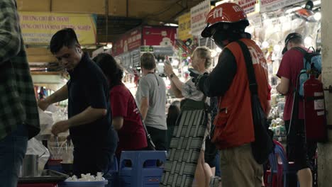 Bustling-Ben-Thanh-market-with-locals-and-tourists-in-Saigon,-Vietnam,-during-the-day