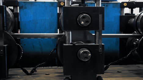 Close-up-of-conveyor-belt-in-a-factory-along-which-aluminium-panels-move-for-the-production-of-high-tech-products