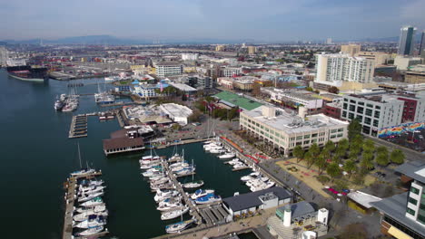 Oakland-California-USA,-Drone-Shot-of-Waterfront-Buildings,-Promenade-and-Marina-in-Estuary-and-Inner-Harbor