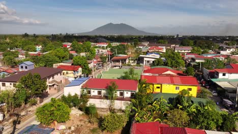 Drone-flight-over-colorful-roofs-of-houses-in-Balibago-Suburb-at-sunny-day