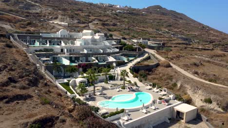 Aerial-Orbit-of-Luxurious-Resort-with-a-Pool-in-Imerovigli,-Santorini