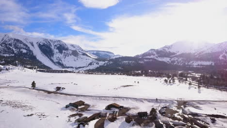 Mammoth-Lakes-Sierra-Mountains-California-aerial-cinematic-drone-flight-winter-spring-sunny-beautiful-snow-covered-town-June-Lake-Crowley-Bishop-skatepark-open-space-cabins-The-Station-upward-movement