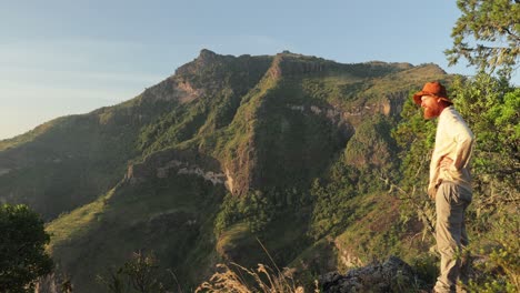 A-white-bushman-looks-over-a-mountain-range-in-Eastern-Uganda-while-hiking-in-Africa