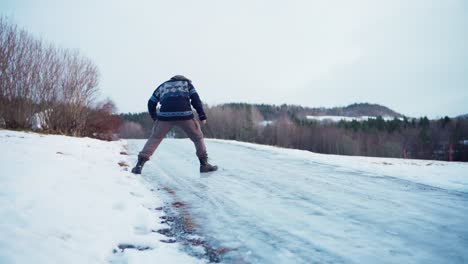 A-Man-Is-Trying-To-Step-Over-Icy-Ground