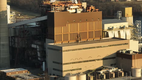 Telephoto-aerial-shot-of-industrial-Flint-Creek-Power-Plant-buildings,-tilt-down