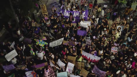 Low-flyover-Women's-Day-marchers-at-night-in-Santa-Cruz,-Bolivia