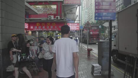 Pedestrians-in-Hong-Kong,-Wan-Chai-area-of-the-city,-walking-in-slow-motion