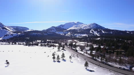 Mammoth-Lakes-Sierra-Mountains-California-aerial-cinematic-drone-flight-winter-spring-sunny-beautiful-snow-covered-town-June-Lake-Crowley-Bishop-skatepark-upward-movement