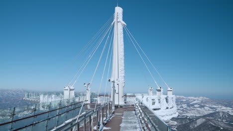 Balwangsan-Ki-Skywalk-Observation-Deck-Against-Blue-Sky-in-WInter,-Pyeongchang-County,-South-Korea---pan