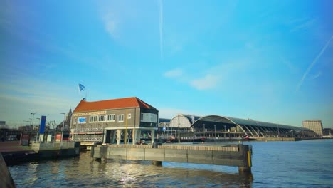 Exterior-of-Naco-house-and-Amsterdam-central-station-wide-angle-during-daytime