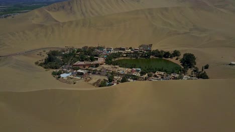 Huacachina-Oasis-Surrounded-by-Sand-Dunes-at-Atacama-Desert,-Peru,-South-America