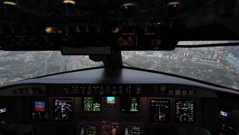 Jet-cockpit-scene-shot-just-before-night-time,-overflying-Valencia-city,-Spain