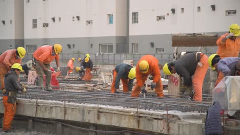 Construction-workers-in-high-visibility-gear-working-on-site,-daytime