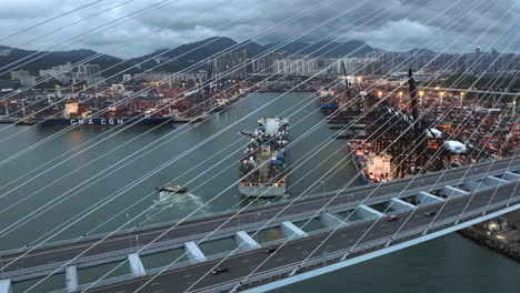 Hong-Kong-container-port-with-container-ships---Cinematic-Drone-crane-shot-on-cloudy-day