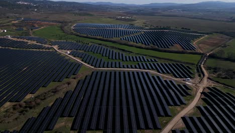 Vast-solar-panel-array-in-serene-Portugal-countryside---aerial-slow-flyover