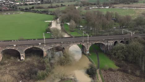 Aerial-view-of-Haversham-and-Little-Linford-viaduct-on-an-overcast-day-showing-local-flooding-from-River-Great-Ouse,-Milton-Keynes,-England