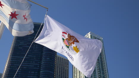 Illinois-flag-waving-in-slow-motion-with-skyscrapers-and-blue-skies-in-the-background,-4K-slow-motion