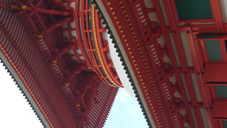 Low-angle-view-of-the-vibrant-red-Konpon-Daito-Pagoda-in-Koyasan,-showcasing-intricate-architecture,-vertical-video