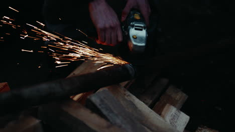 Operating-an-angle-grinder-to-remove-the-imperfections-of-welding-tubes-together