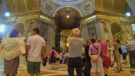 Tourists-in-baroque-St-Peter-Basilica-interior-in-Vatican-City-wide-angle