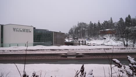 Traffic-heading-both-directions-on-the-E18-motorway-in-front-of-a-Varner-building