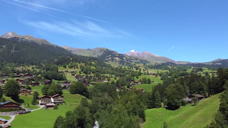 Lauterbrunnen-townscape-and-waterfall-drone-aerial-view-above-swiss-mountains-in-alps