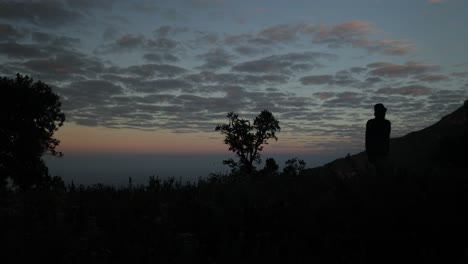 An-African-man-walking-along-a-mountain-in-the-early-morning-sun-in-Eastern-Uganda