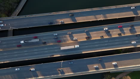 Aerial-birds-eye-view-of-traffic-crossing-a-highway-bridge