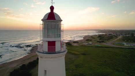 Sunrise-at-Farol-lighthouse-with-ocean-view,-aerial-shot,-tranquil-morning