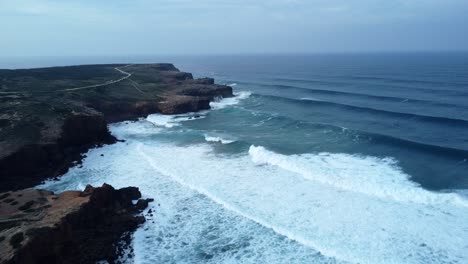 Drone-shot-of-waves-crashing-into-rocks