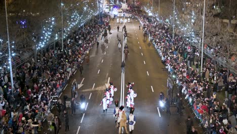 Float-riders-at-the-Three-Wise-Men-festival,-also-known-as-the-Three-Kings-Parade,-join-families-and-spectators