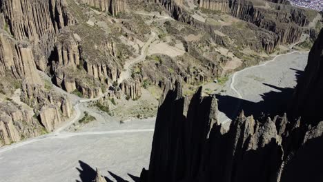 Descending-aerial-reveals-tall-eroded-rock-spires-near-La-Paz,-Bolivia