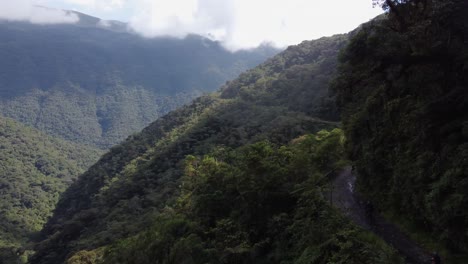 Aerial-follows-cyclists-descending-famous-Yungas-Death-Road,-Bolivia