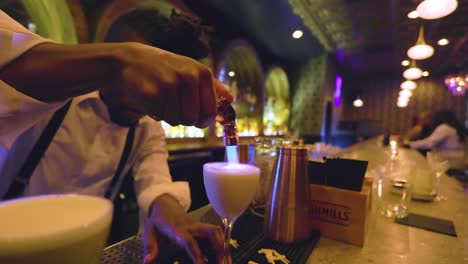 black-male-bartender-is-using-a-blow-torch-to-set-the-drinks-on-fire-in-a-black-owned-bar-in-the-city