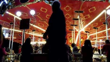 The-vibrant-carousel-spins-with-colorful-lights-in-a-joyous-frenzy,-capturing-the-excitement-and-laughter-of-children-in-a-whimsical-time-lapse-scene