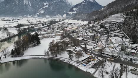 Walensee-Switzerland-view-of-skiing-village-at-base-of-mountain-rotating-aerial