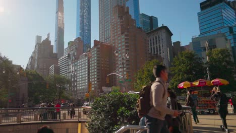 City-commuters-exit-Central-Park-subway-under-the-towering-Manhattan-metropolis